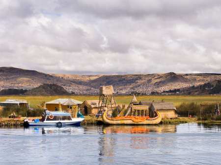 Men with traditional & modern boats in Reed Islands, Peru on Lake Titicaca.のeditorial素材