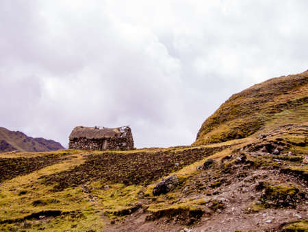 Primitive stone house in the Andes mountains of Peru above treeline.のeditorial素材