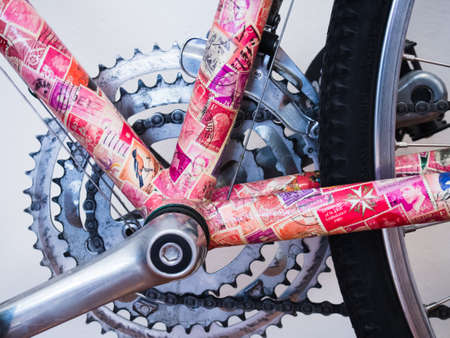 Bike with bright pink collage and chain & wheelの写真素材