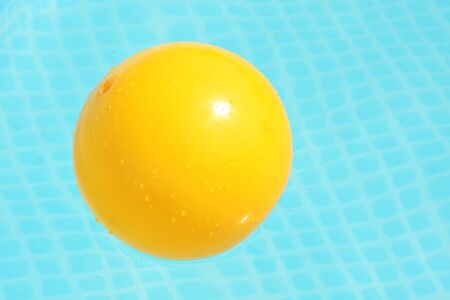 Yellow ball in swimming pool. Looks like a egg yolk.の写真素材