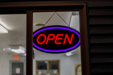 Neon open sign in window at night