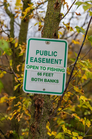 Easement sign to notify public fishing is allowed. Selective focus, background and foreground blur.の写真素材