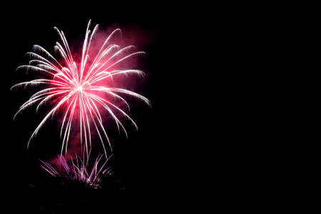 Colorful fireworks celebration in the night sky with free space for text