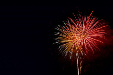 Colorful fireworks celebration in the night sky with free space for textの写真素材