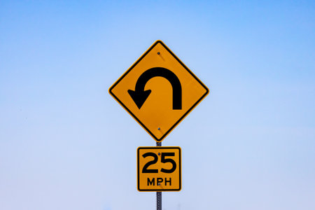 Sign indicating 25 mile per hour curve ahead in the Badlands National Park.の写真素材
