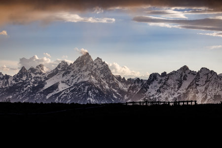 Landscape of the snow covered Teton Mountain range with heavy cloud cover in Grand Teton National Park, Wyoming, USAの写真素材