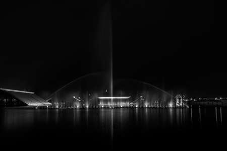 Fountain under the light at nightの写真素材