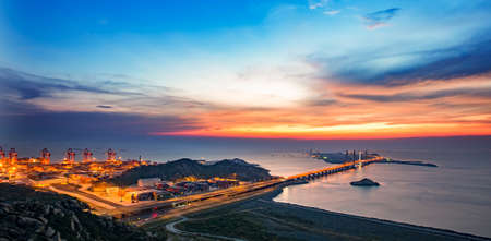 Landscape view of the sea and operation field during sunsetの写真素材