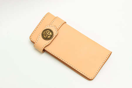 Women's long leather wallet in neutral leather tone isolated on a white backgroundの写真素材