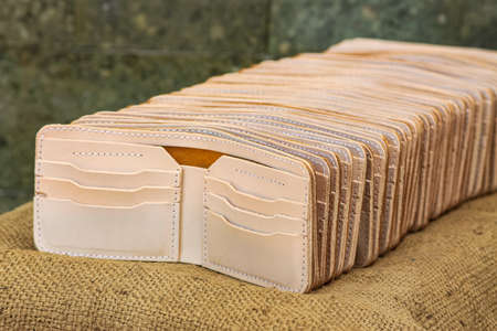 Handmade Leather. Men's brown leather wallet. With a touch of a netted background or textureの写真素材