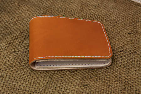 Handmade Leather. Men's brown leather wallet. With a touch of a netted background or textureの写真素材