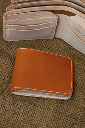 Handmade Leather. Men's brown leather wallet. With a touch of a netted background or textureの写真素材