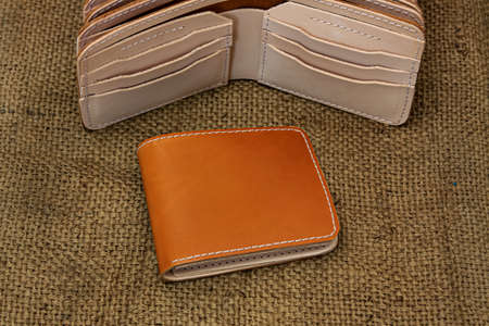 Men's brown leather wallet. With a touch of a netted background or texture.の写真素材