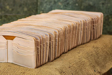 Men's brown leather wallet. With a touch of a netted background or texture.の写真素材
