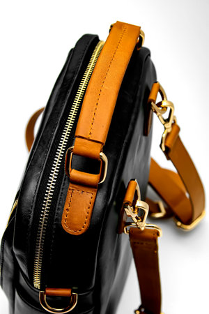 Classic black leather bag with white background isolation.の写真素材