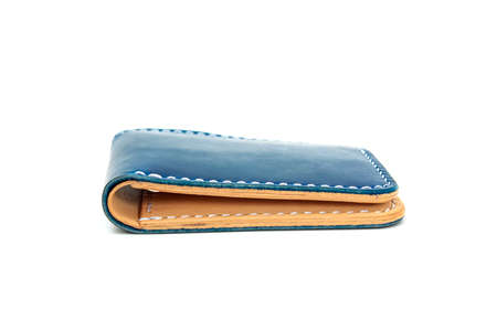 Blue natural leather wallet isolated on a white background. Closeup expensive wallet. Leather craft. Homemade.の写真素材