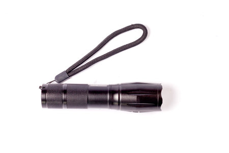 LED flashlight with spotlight for hiking at night. battery powered flashlight on white background. Pocket flashlight on white backgroundの写真素材