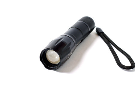 LED flashlight with spotlight for hiking at night. battery powered flashlight on white background. Pocket flashlight on white backgroundの写真素材