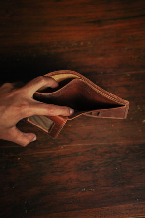 Wallet, cards, credit. Stylish leather wallet in box on wooden background. Leather wallet on wood texture. Leather craftsman. Leather Craft.の写真素材