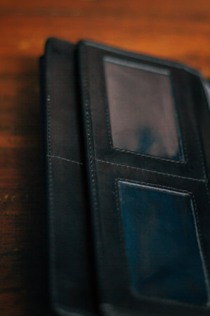 Wallet, cards, credit. Stylish leather wallet in box on wooden background. Leather wallet on wood texture. Leather craftsman. Leather Craft.の写真素材