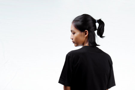 Asian men. Young Asian man close up shot isolated on white. Young Asian man wearing a plain black t-shirt isolated on a white background.の写真素材