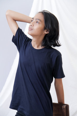 Clothing model. Young Asian man with long curly hair close up shot isolated on white. Asian young...