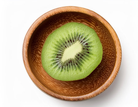 fresh kiwi slice in wooden bowl isolated on white backgroundの写真素材