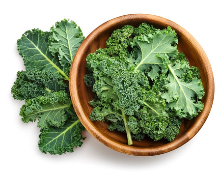 Whole and sliced kaleÂ in wooden bowl isolated on white backgroundの写真素材