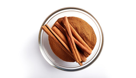 Cinnamon sticks in a transparent glass bowl isolated on white background