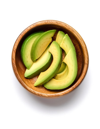 Avocado slicesÂ in wooden bowl isolated on white backgroundの写真素材