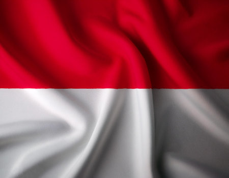 Indonesia flag waving in the wind. Close up of Indonesia banner blowing, soft and smooth silk. Cloth fabric texture ensign background. Use it for national day and country occasions conceptの写真素材