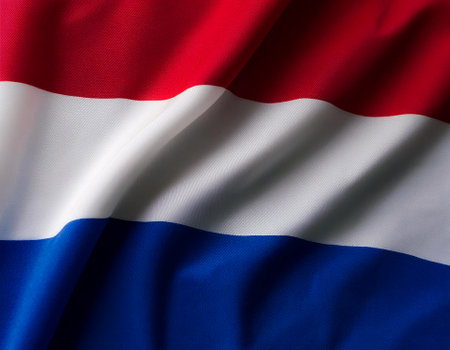 Dutch flag waving in the wind. Close up of Dutch banner blowing, soft and smooth silk. Cloth fabric texture ensign background. Use it for national day and country occasions conceptの写真素材