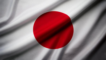 Japan flag waving in the wind. Close up of Japan banner blowing, soft and smooth silk. Cloth fabric texture ensign background. Use it for national day and country occasions conceptの写真素材