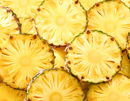 Fresh sweet pineapple slices pattern backgrond, close upの写真素材