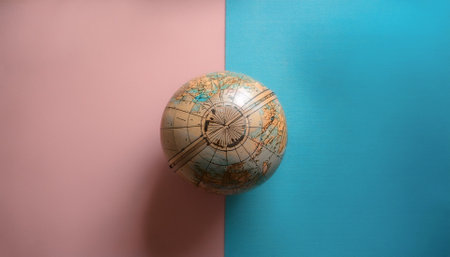 Ancient globe, isolated on a Soft blue and Pink Pastelの写真素材