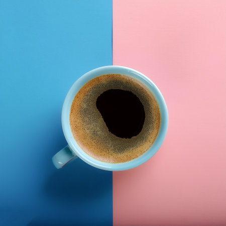 A cup of black coffee with froth on top, isolated on a soft blue and Pink Pastelの写真素材