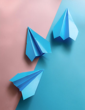 blue paper planes, isolated on a soft blue and Pink Pastelの写真素材