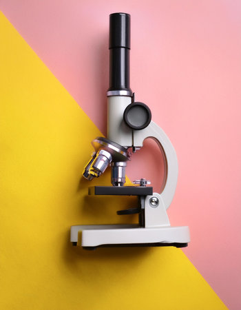 microscope, isolated on a Yellow and Pink Pastelの写真素材