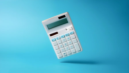 Calculator floating or flying isolated on light blue backgroundの写真素材