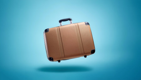 Classic suitcase floating or flying isolated on light blue backgroundの写真素材