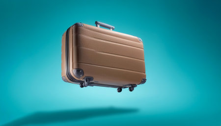 Classic suitcase floating or flying isolated on light blue backgroundの写真素材