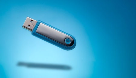 Mini Flash drive floating or flying isolated on light blue backgroundの写真素材