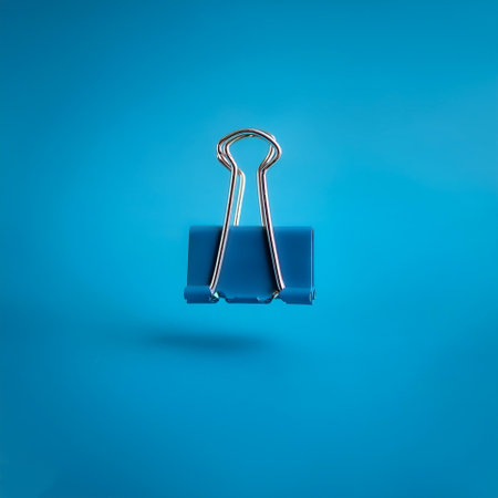Binder clips floating or flying isolated on light blue backgroundの写真素材