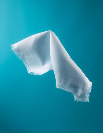 Handkerchief floating or flying isolated on light blue backgroundの写真素材