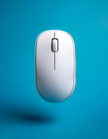 White Wireless mouse without cables floating or flying isolated on light blue backgroundの写真素材