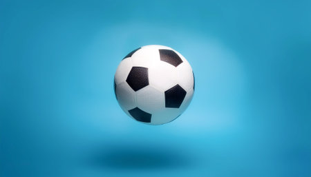White and black soccer ball floating or flying isolated on light blue background