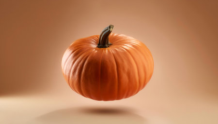 pumpkin floating or flying isolated on biege backgroundの写真素材