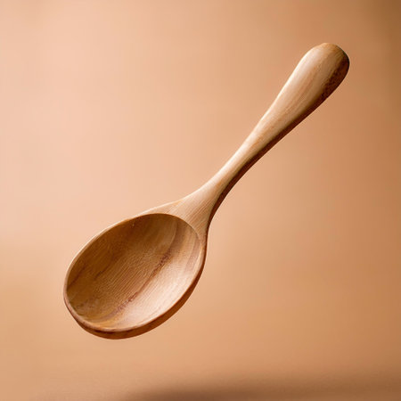 Wooden spoon floating or flying isolated on biege backgroundの写真素材