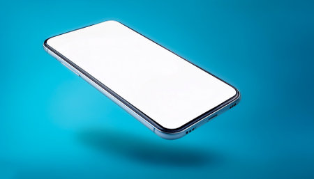 Smartphone with bright white screen floating or flying isolated on light blue backgroundの写真素材