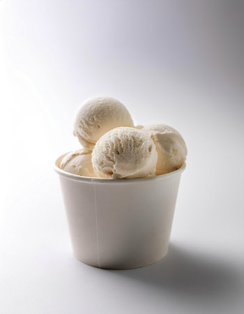Ice cream balls in paper cup isolated whiteの写真素材
